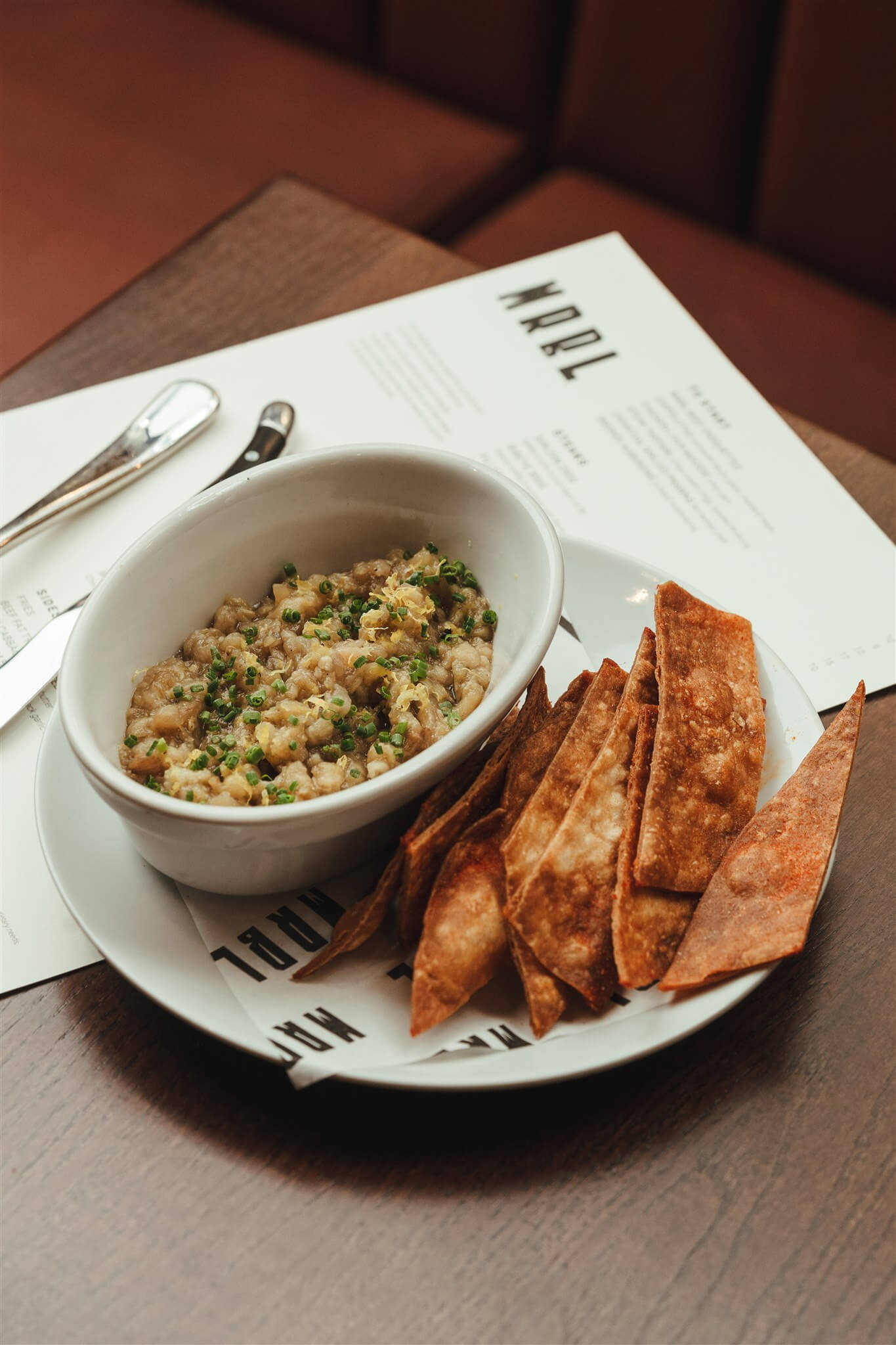 Smoky aubergine dip with flatbread crisps on branded MRBL paper